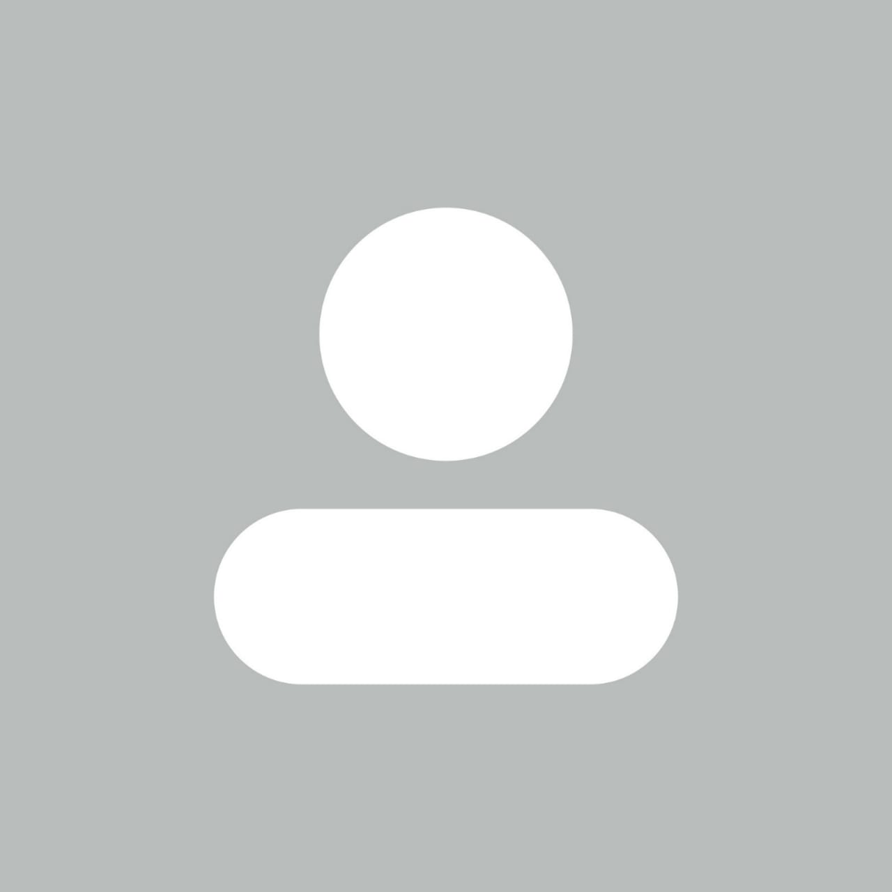 Ícone minimalista de uma pessoa, consistindo de um círculo acima de uma forma retangular arredondada, em cores cinza e branco.